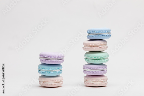 On a table with a white background, there are colorful model macaroons. 
