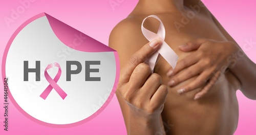 Composition of pink ribbon logo and hope text, with woman covering bust with hands