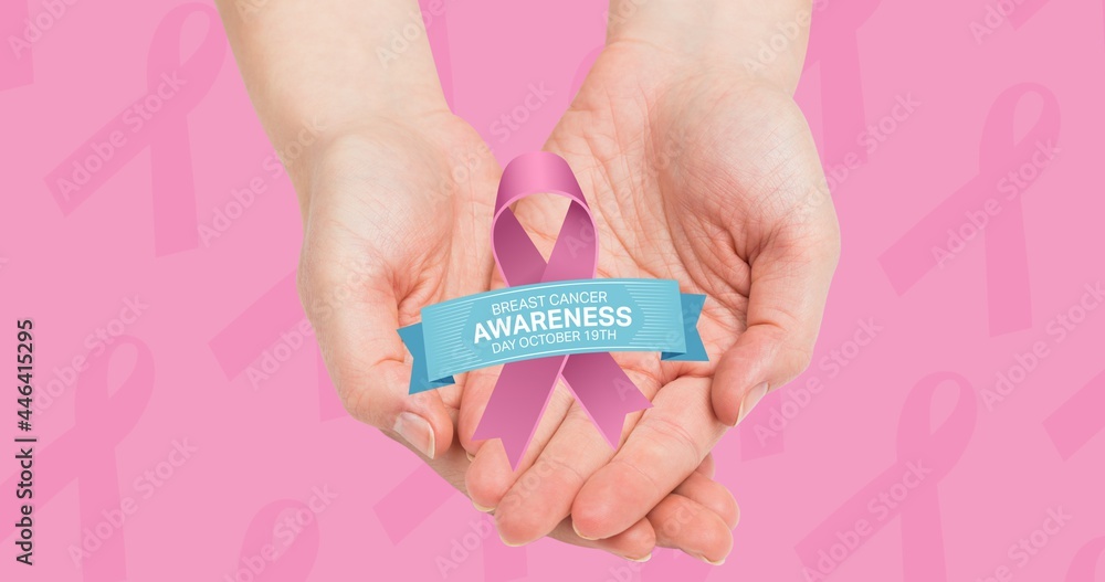 Composition of pink ribbon logo and breast cancer text above hands Composition of pink ribbon logo and breast cancer text above hands
