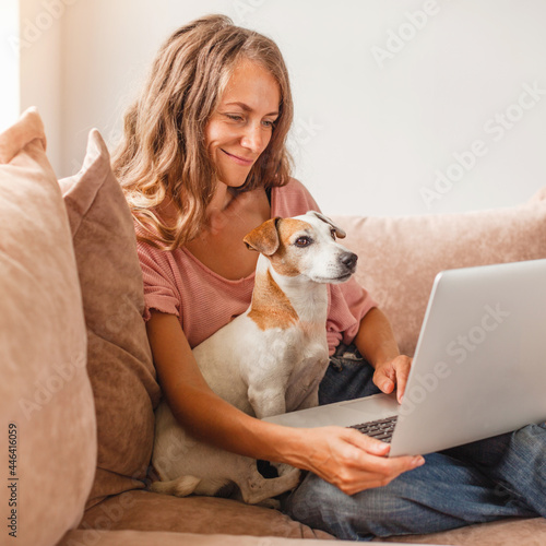 Cheerful woman using silver laptop