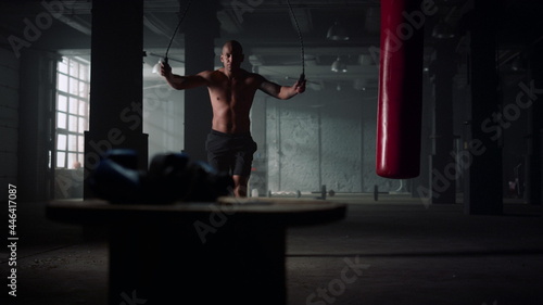 Guy preparing for cardio workout with jump rope. Man jumping on skipping rope © stockbusters