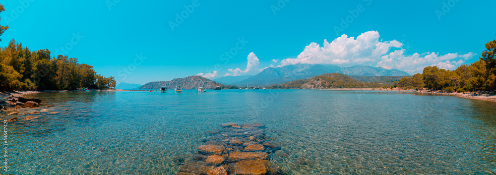 Panoramic view of Phaselis Beach and Bey Mountains on the background. Tekirova Antalya Turkey. South harbor of Phaselis Ancient City in Antalya. Tourism in Turkey.