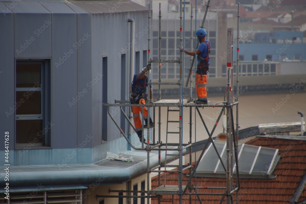 Two workers on a scaffold