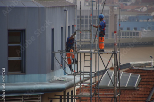 Two workers on a scaffold