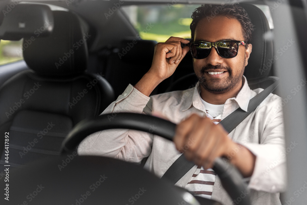 transport, vehicle and people concept - happy smiling indian man or driver in sunglasses driving car transport, vehicle and people concept - happy smiling indian man or driver in sunglasses driving car