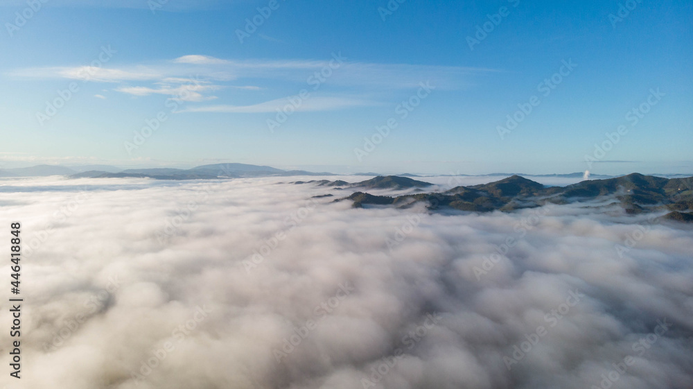 Fog with mountain. Sky with clouds.