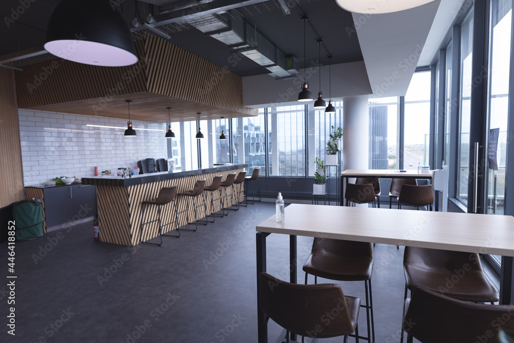 Fototapeta premium Interior of empty cafeteria with tables in modern office