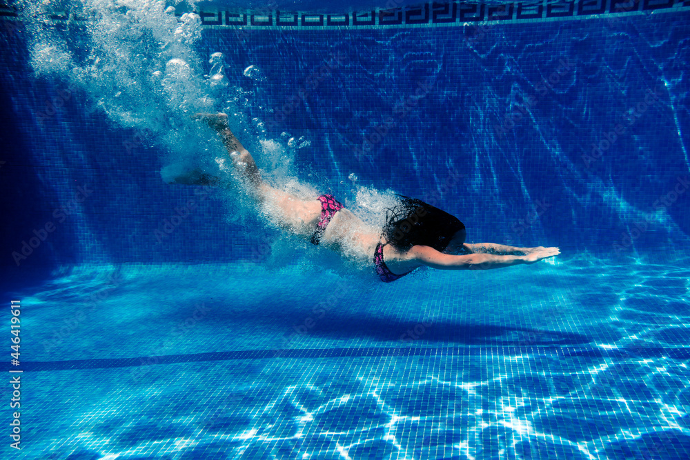 caucasian woman diving in swimming pool. underwater view. Summer time and vacation concept