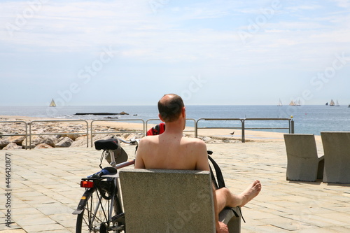 There is a man in summer beach in Barcelona, Spain 