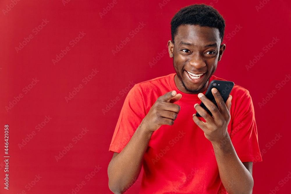 happy african man talking on the phone on a red background happy african man talking on the phone on a red background
