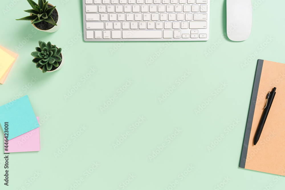 Minimal work space - Creative flat lay photo of workspace desk. Top view office desk with keyboard, mouse and book on pastel green color background. Top view with copy space, flat lay photography. Minimal work space - Creative flat lay photo of workspace desk. Top view office desk with keyboard, mouse and book on pastel green color background. Top view with copy space, flat lay photography.