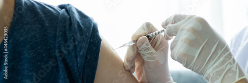 Fotografie Asian young man very scare a vaccination shot, man having a needle phobia problem