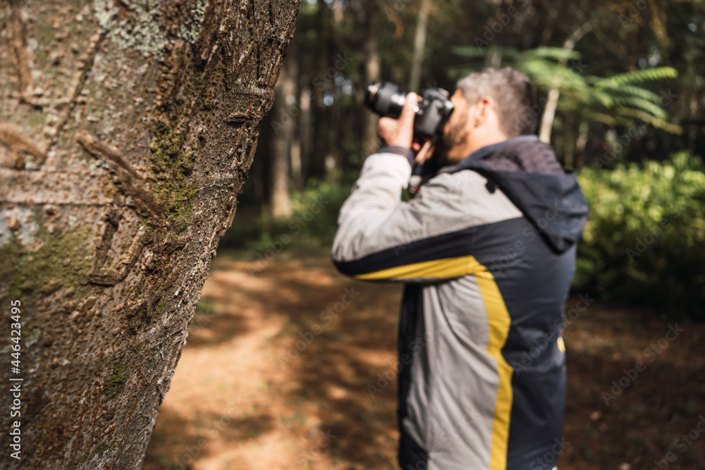 Portrait of a photographer photographing in a park. Portrait of a photographer photographing in a park.