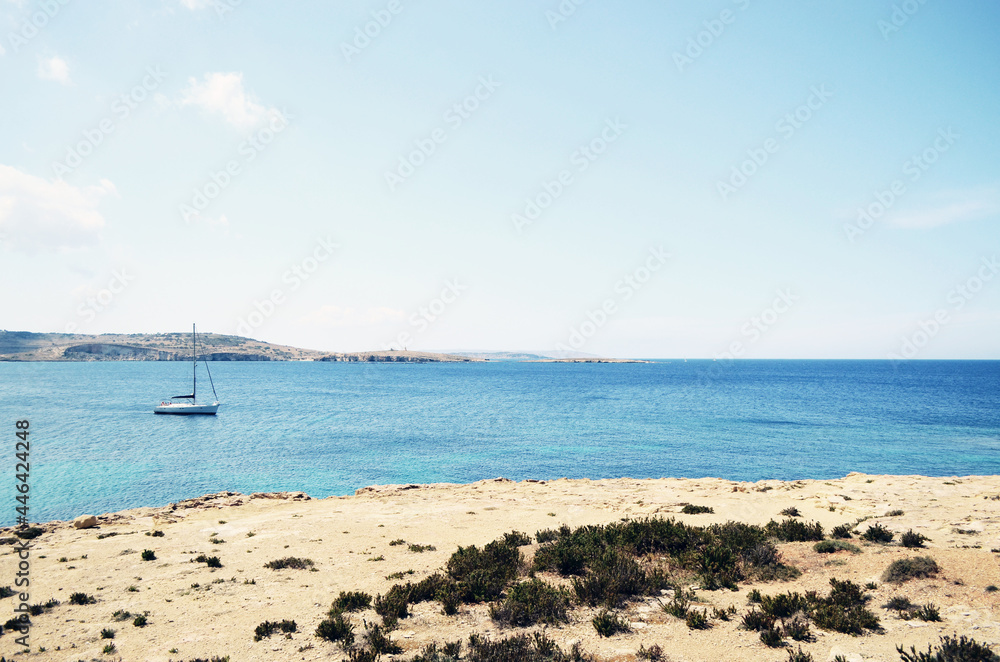 MALTA, VALETTA: Scenic landscape view of the rocky seashore with boats in the sea MALTA, VALETTA: Scenic landscape view of the rocky seashore with boats in the sea
