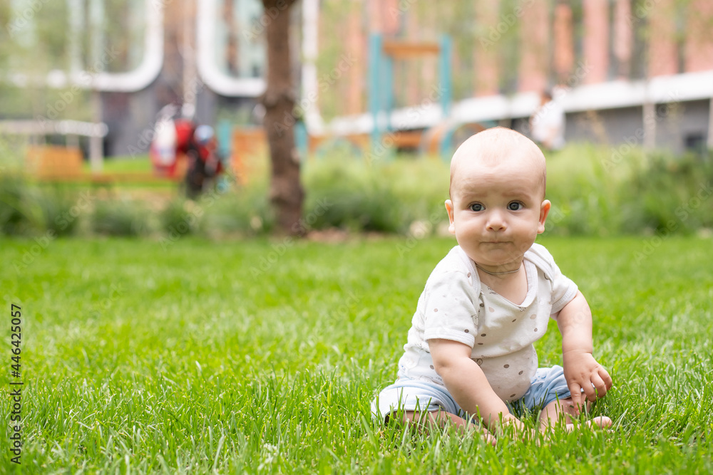 Little baby on fresh green grass outdoors Little baby on fresh green grass outdoors