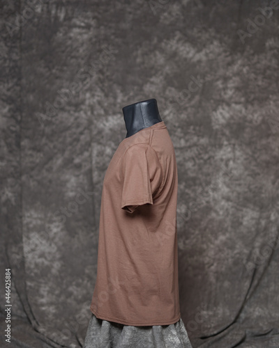 Brown man blank t-shirt template, side view, natural shape on invisible mannequin, for your design mockup for printing, isolated on gray motif background. Free space for your ad. photo