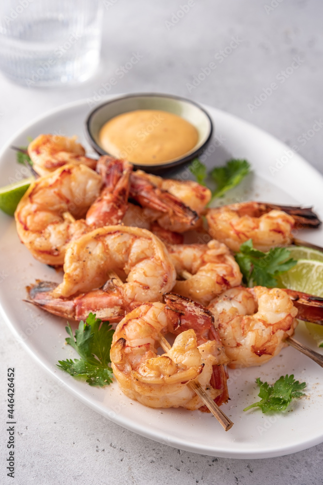 Grilled shrimps. Shrimps skewers, lime and sauce Grilled shrimps. Shrimps skewers, lime and sauce