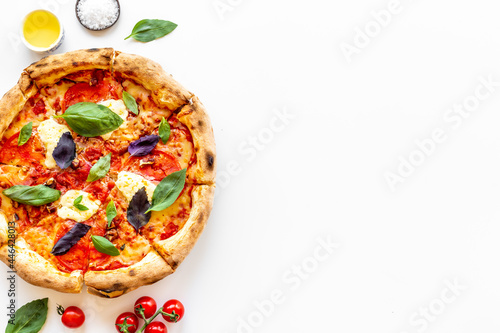 Delicious pizza with cheese tomatoes sauce and basil