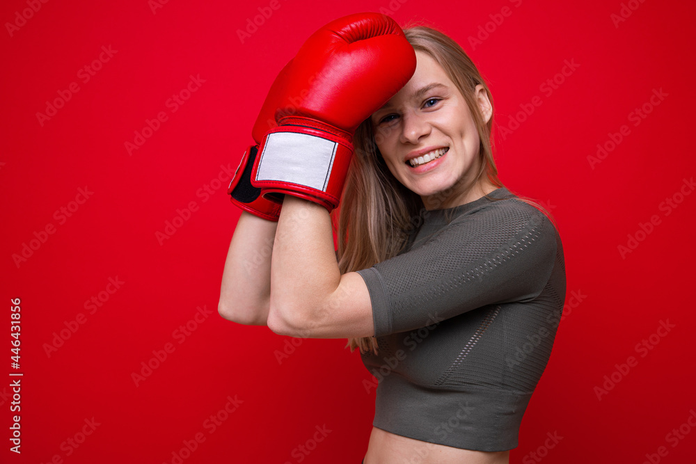 Athletic young woman in red boxing gloves in training Athletic young woman in red boxing gloves in training