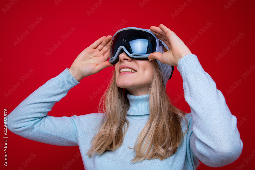 Portrait of a young woman in a sweater and ski goggles Portrait of a young woman in a sweater and ski goggles