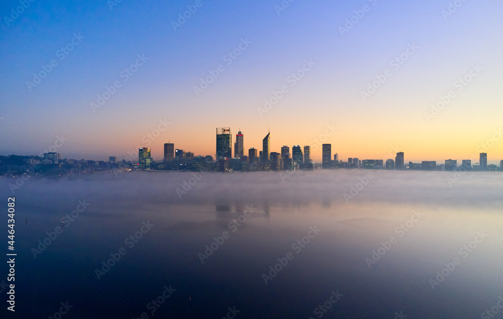Perth skyline at dawn with fog on the Swan River surrounding the CBD Perth skyline at dawn with fog on the Swan River surrounding the CBD