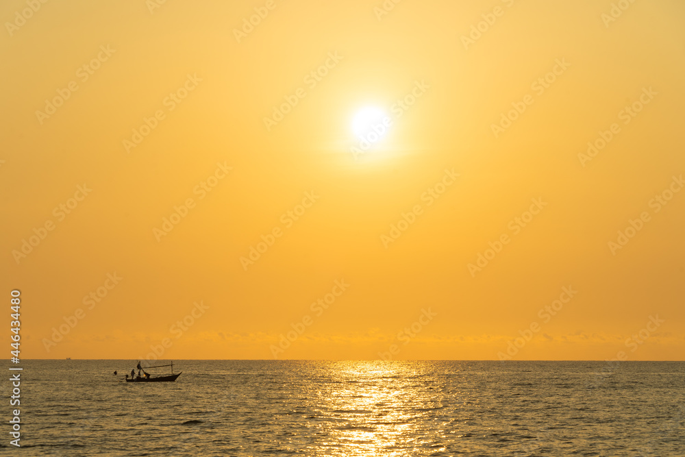 Silhouette fishing boat under sunrise, golden view