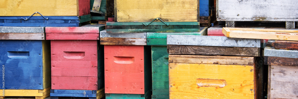 Pile of colorful beehives background, panoramic web banner