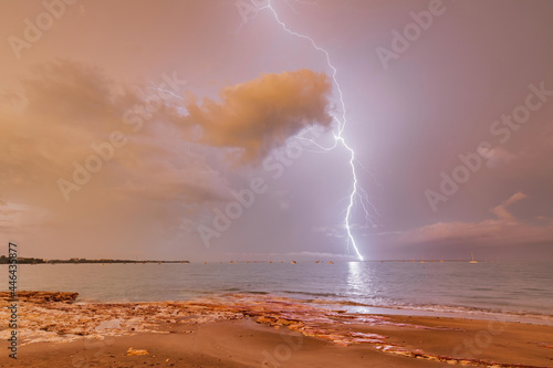 Lightning strike over Fannie Bay during sunrise photo
