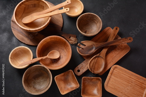 Culinary background, empty ceramic plates, wooden or bamboo spoons and bowls . Rustic style. Home Kitchen Décor.