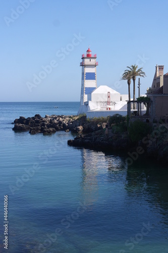 Aesthetics rest for the eyes: portugal harbor with picturesque lighthouse, shores of the atlantic azure ocean with blue white red stripes. Cascais, Fresh breeze breathtaking attraction experience. 