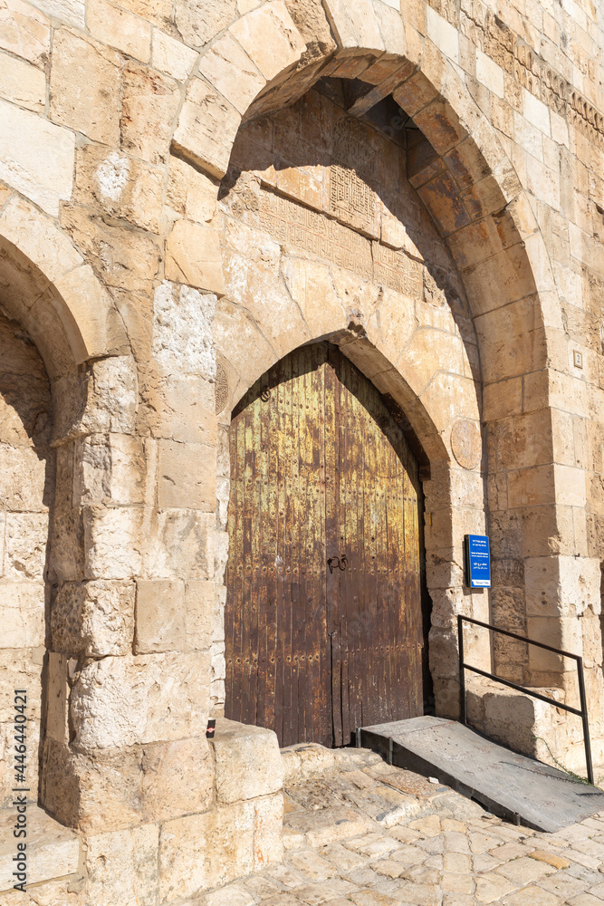 The entrance iron gate in the outer wall of the Tower of David - ancient citadel and city history museum near the Jaffa Gate in the old city of Jerusalem, Israel