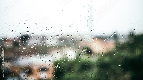 Close up macro shot falling rain water drops bubbles on wet window glass flat house appartment nature blur bokeh background, condensation on the surface, droplet plash steam drip, copy space 