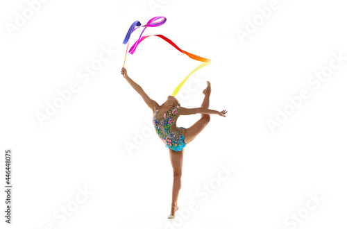 Young beautiful girl, rhythmic gymnast with colored ribbon in motion isolated on white studio background. photo