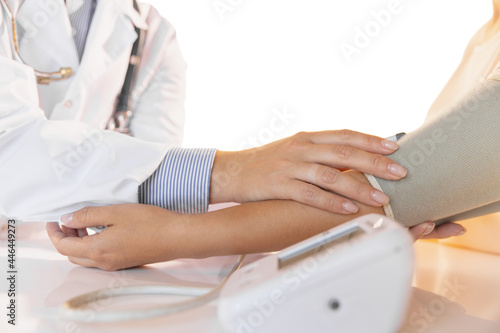 Close-up hands of doctor  therapeutic or medical advisor measuring pulse to patient  sick. Concept of healthcare  care and medicine.