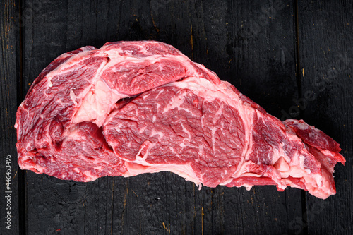 Raw fresh organic top choice meat ribeye steak, on black wooden table background, top view flat lay