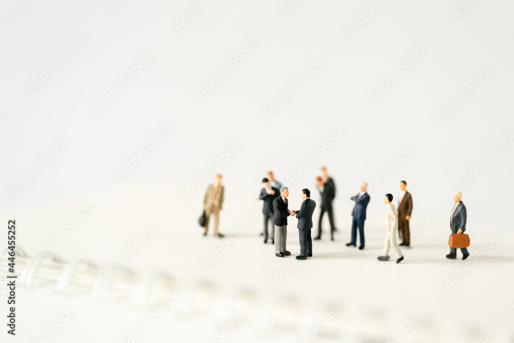 Miniature businessman shake hand partner client customers on stage with success dealing business using as contract commitment agreement investment and partnership business development joint venture Miniature businessman shake hand partner client customers on stage with success dealing business using as contract commitment agreement investment and partnership business development joint venture