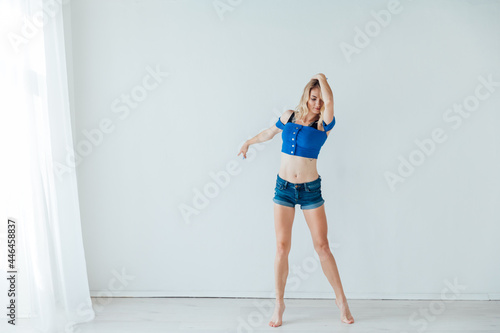 blonde woman dancing to music in training