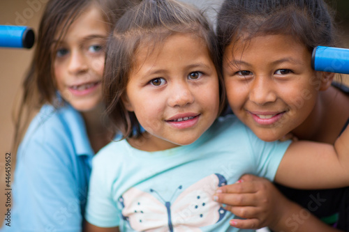 Three little kids close together head and shoulders