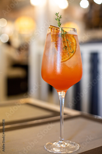 Closeup glass of sparkling wine cocktail decorated with grapefruit at cafe background