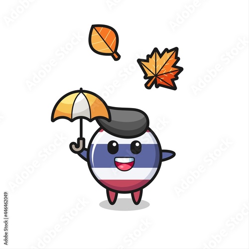 cartoon of the cute thailand flag badge holding an umbrella in autumn