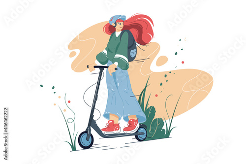 Smiling girl riding on electric scooter