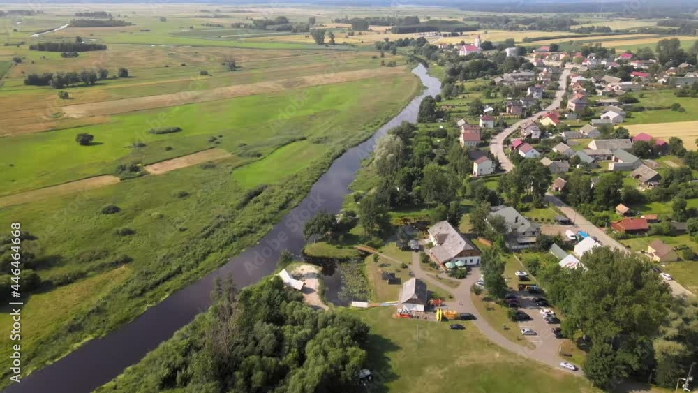 Top view of the town of Suraż on the Narew River.Landscape of the meandering Narew River in its valley,where the Narew National Park begins. Top view of the town of Suraż on the Narew River.Landscape of the meandering Narew River in its valley,where the Narew National Park begins.
