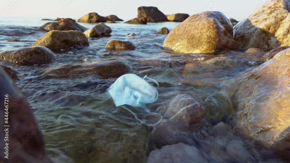 Coronavirus outbreak trash in the ocean. Disposable masks, medical gloves and used personal protective equipment. Plastic pollution threatening the health of oceans Coronavirus outbreak trash in the ocean. Disposable masks, medical gloves and used personal protective equipment. Plastic pollution threatening the health of oceans