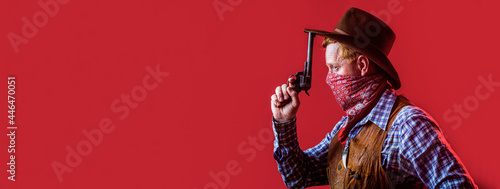 Portrait of a cowboy. American bandit in mask, western man with hat. Portrait of cowboy in hat. Portrait of man wearing cowboy hat, gun. Portrait of a cowboy. West, guns