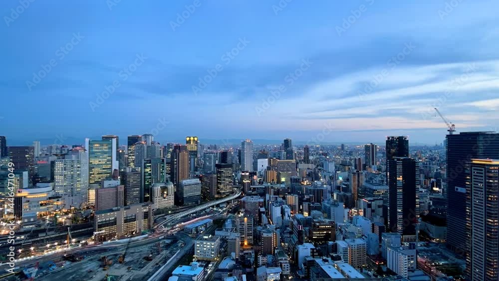 UMEDA, OSAKA, JAPAN : Aerial high angle sunrise view of CITYSCAPE of OSAKA. View of buildings and street around Osaka and Umeda station. Wide view time lapse zoom in shot, night to morning. UMEDA, OSAKA, JAPAN : Aerial high angle sunrise view of CITYSCAPE of OSAKA. View of buildings and street around Osaka and Umeda station. Wide view time lapse zoom in shot, night to morning.