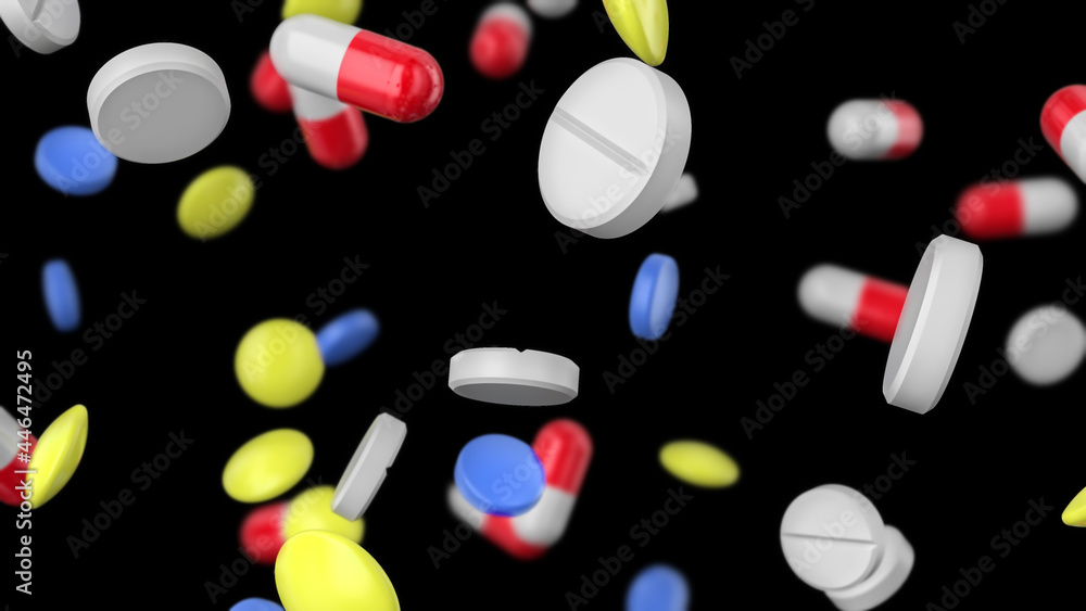 Colored pills of different shapes are falling on a black background. Pharmaceutical concept.
