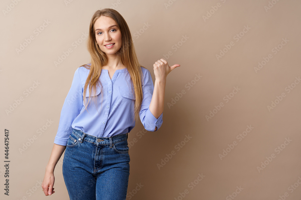 Pretty nice young woman pointing to copy space for advertising Pretty nice young woman pointing to copy space for advertising