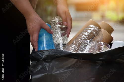 Houseowner is separating garbages beside the streen in front of the house, concept for recycle, reuse, reduce garbages to protect our planet. Soft and selective focus. photo