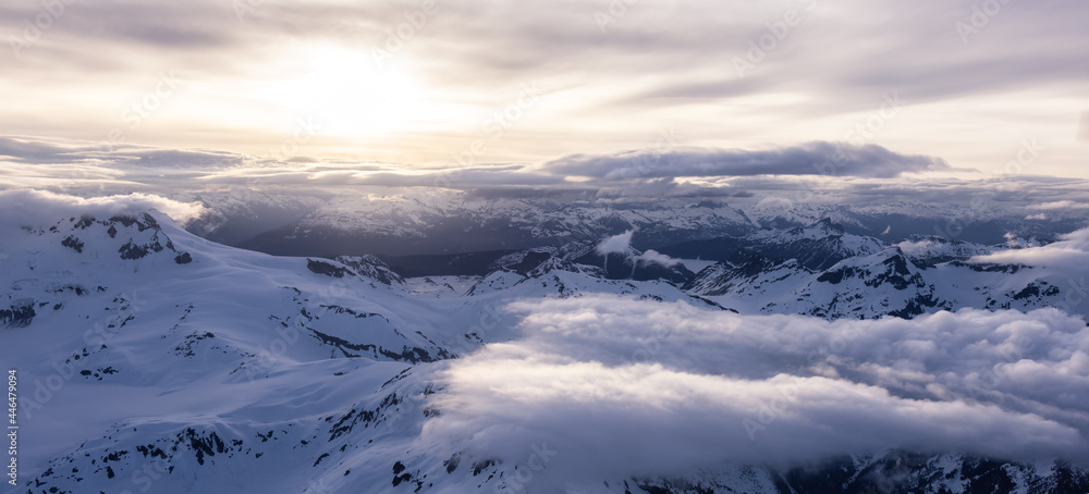 Aerial View from Airplane of Canadian Mountain Landscape in Spring time. Colorful Sunset. Garibaldi near Squamish, North of Vancouver, British Columbia, Canada. Authentic Image Aerial View from Airplane of Canadian Mountain Landscape in Spring time. Colorful Sunset. Garibaldi near Squamish, North of Vancouver, British Columbia, Canada. Authentic Image