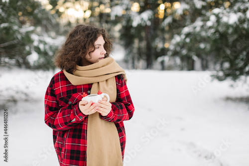 Happy Girl In Red Jachet The Snow Forest. Cold Winter. Cup of tea. photo